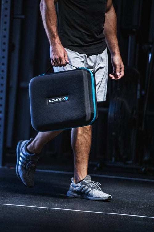 A man carrying the Compex Ayre™ wireless compression boots